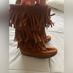 Brown suede moccasin boots.